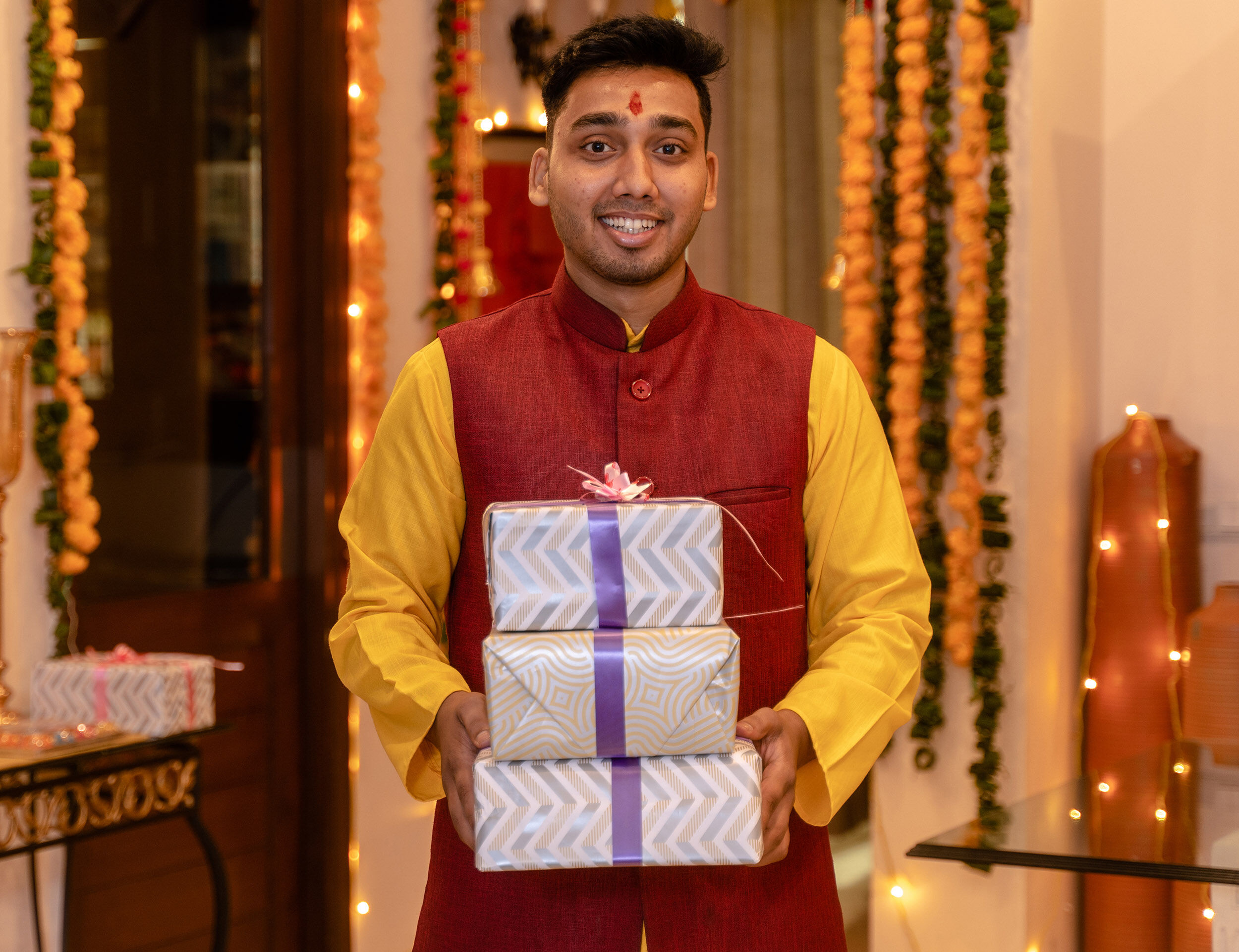 A man wearing a floral patterned floral indo-western jacket set